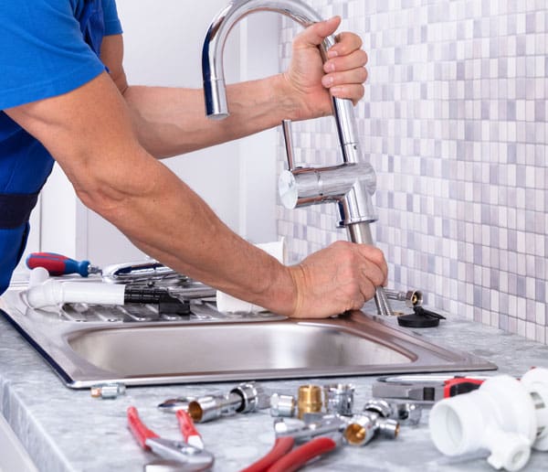 Plumber Installing a New Faucet